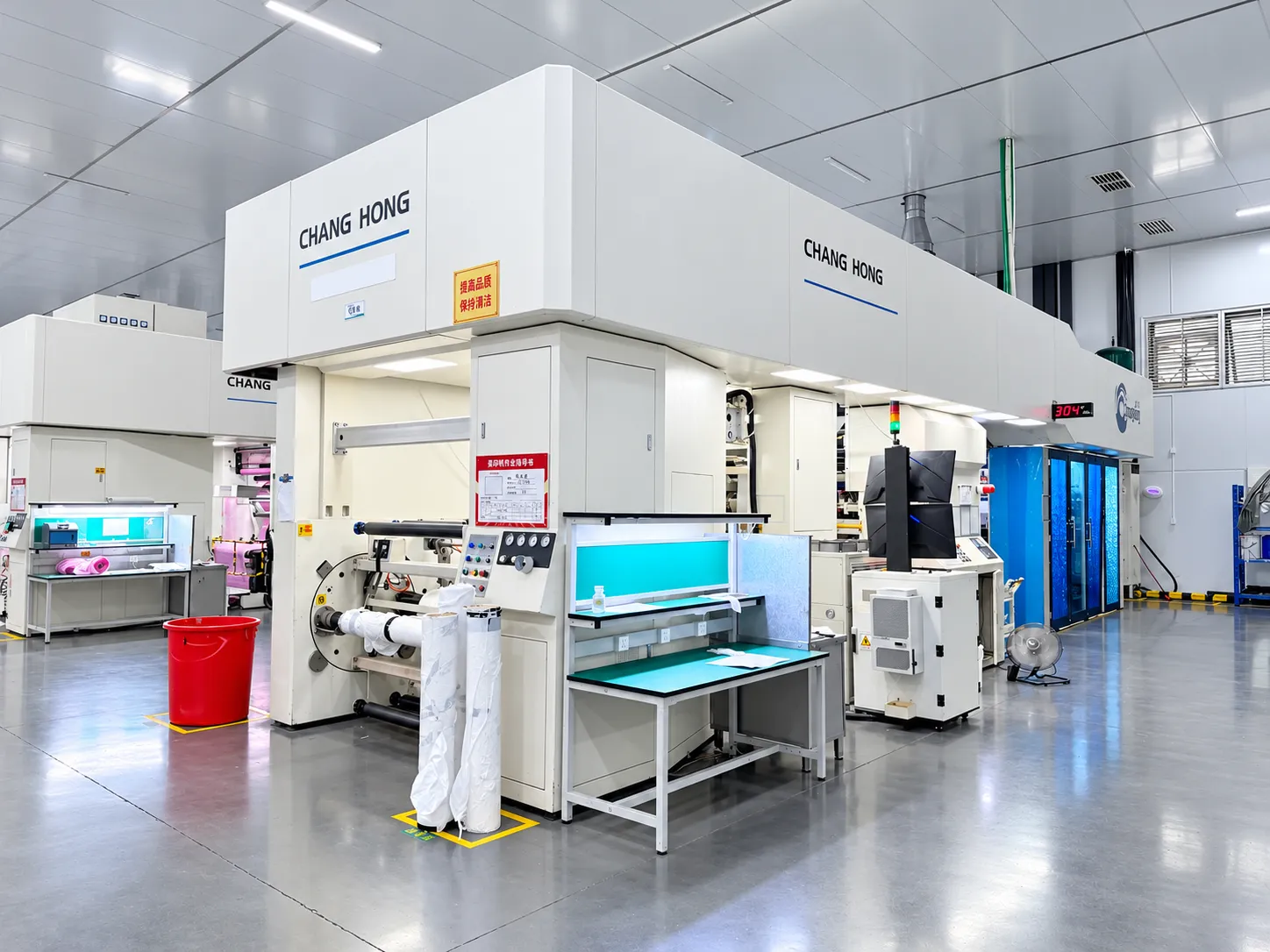 Printing and slitting hall with jumbo hygiene film rolls on the production floor